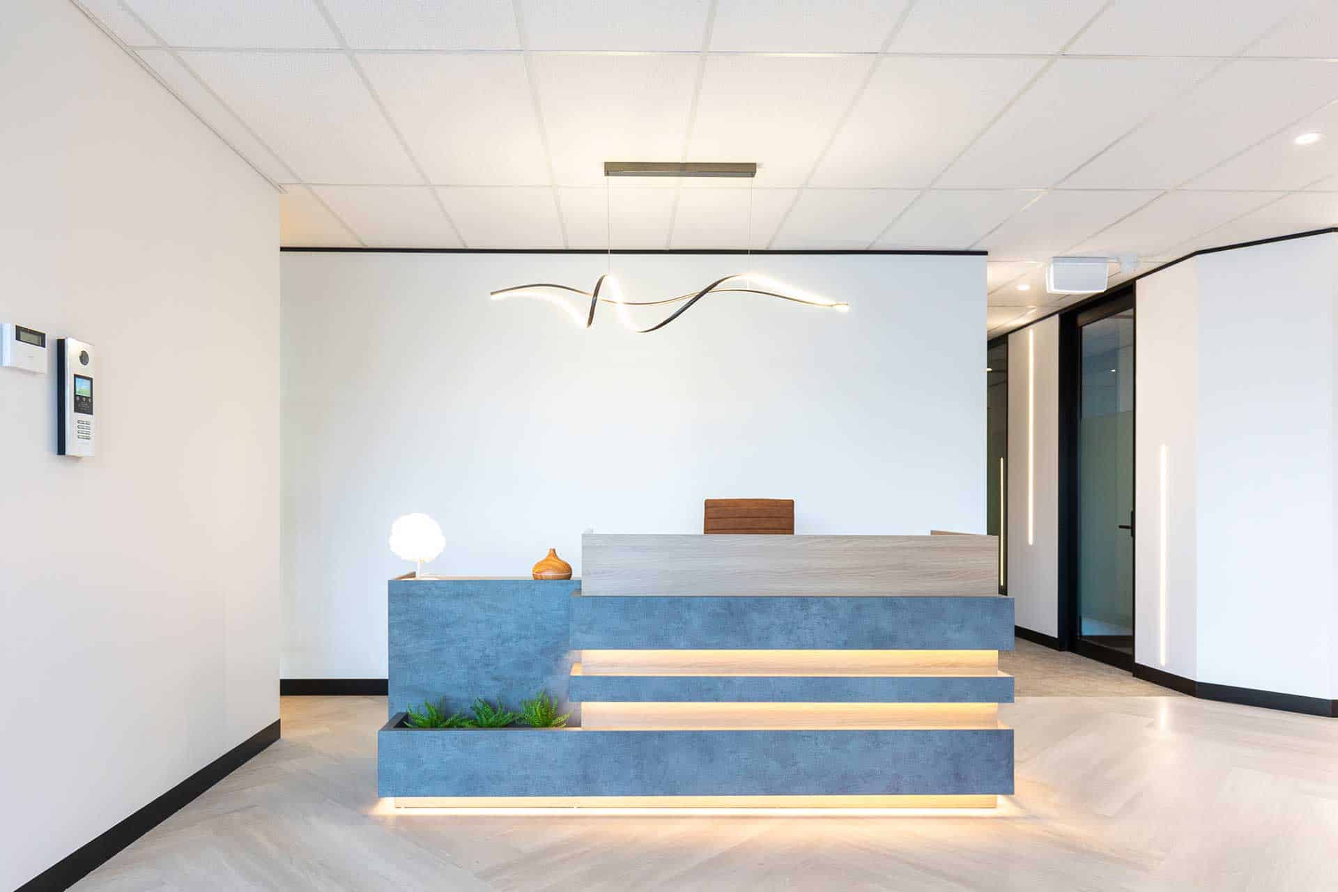 Gold Coast fitout specialist custom-designed reception desk with integrated lighting by Airey Building Group.